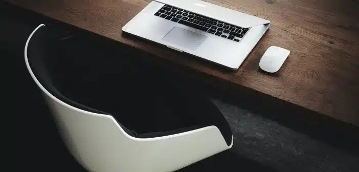 Apple MacBook beside computer mouse on table